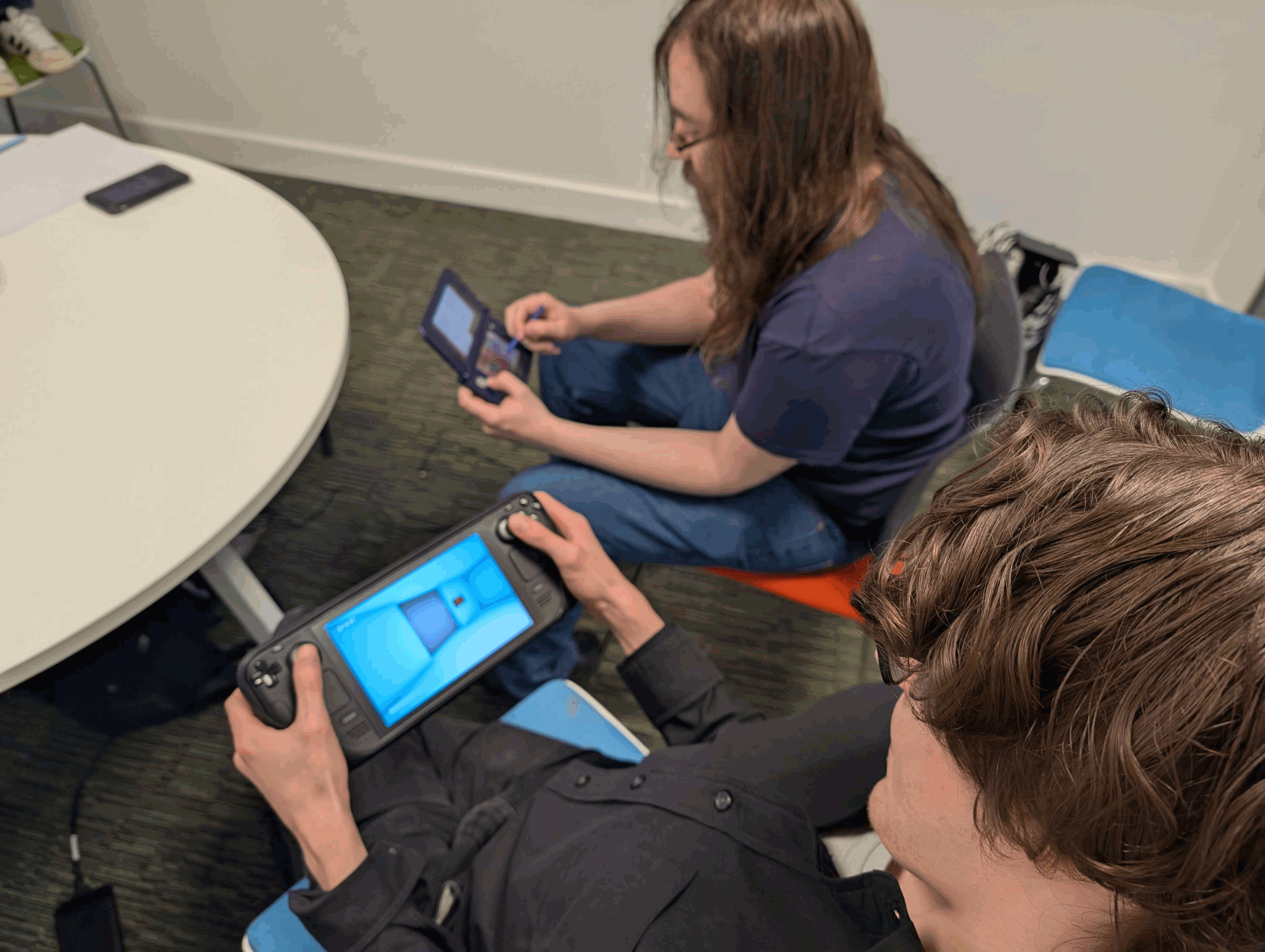 Two players playing F!#&CK Around And Find (your way) Out, with one playing on DS and the other on a Steam Deck